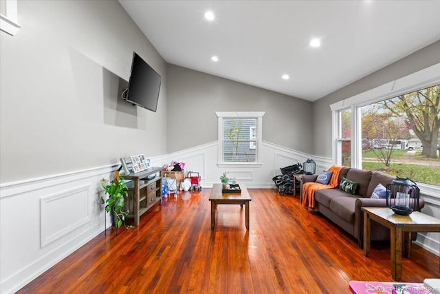 living area featuring a wealth of natural light, recessed lighting, wood finished floors, and vaulted ceiling