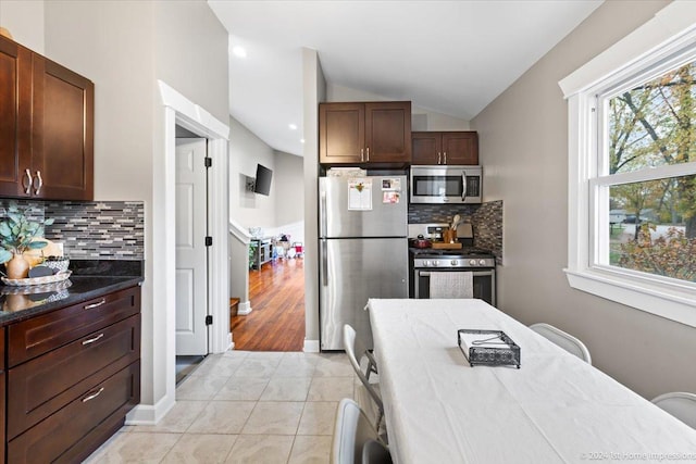 15323 Cherry Ln, Markham, IL 60428 - kitchen with appliances with stainless steel finishes, vaulted ceiling, tasteful backsplash, and light tile patterned floors