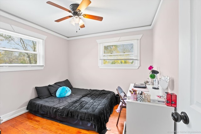 bedroom with ceiling fan, baseboards, light wood-style floors, and ornamental molding