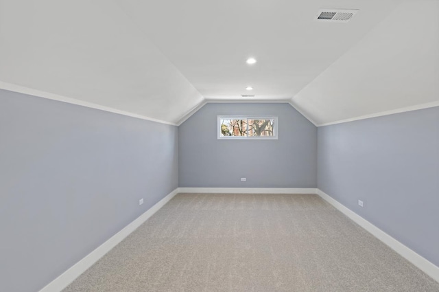 additional living space with light carpet and lofted ceiling