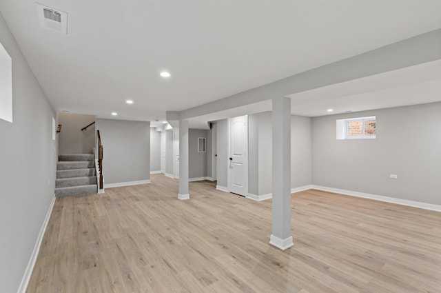 basement with light hardwood / wood-style flooring