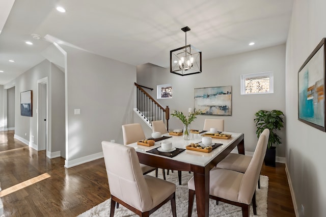 dining room featuring dark hardwood / wood-style floors and a chandelier