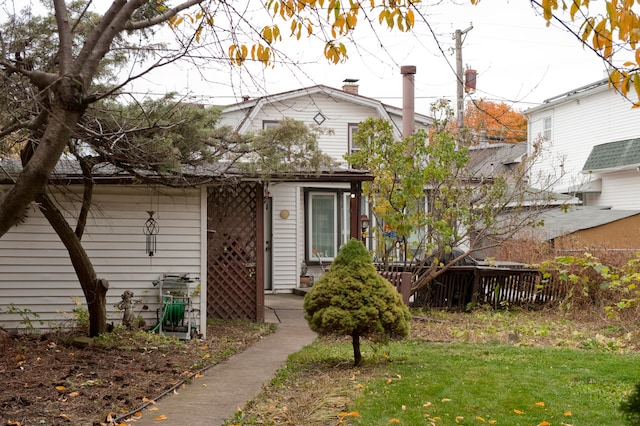 bungalow-style home with a front lawn