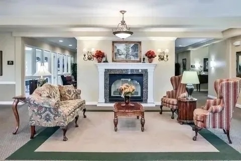 sitting room with carpet and a high end fireplace