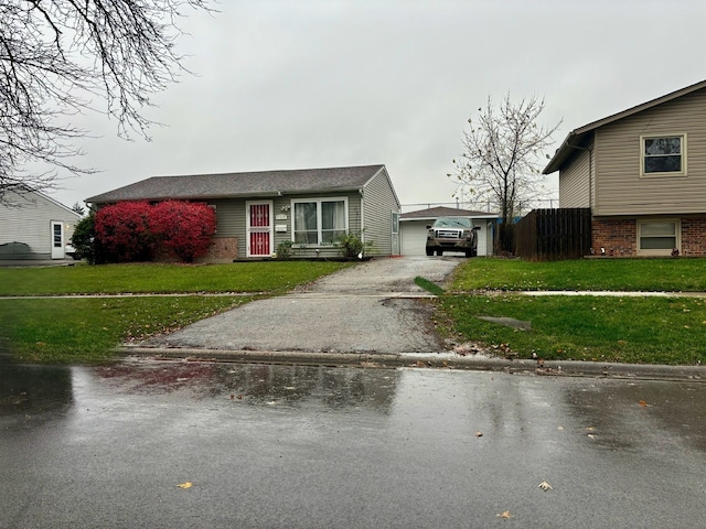 view of front of property with a garage and a front lawn