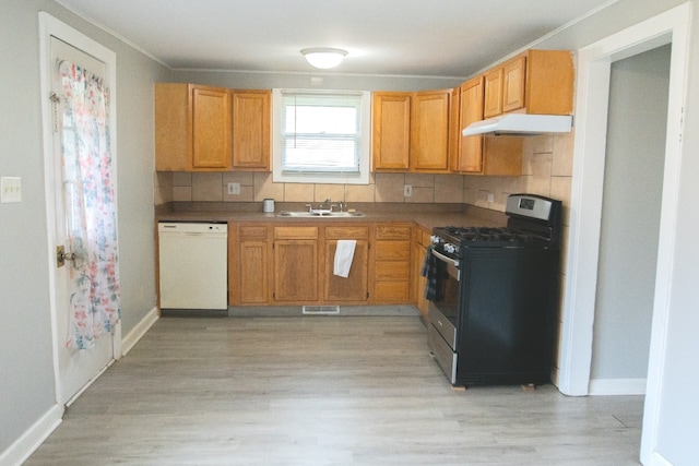 kitchen featuring dishwasher, black gas stove, light hardwood / wood-style floors, and sink