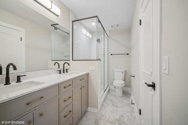 bathroom featuring an enclosed shower, vanity, and toilet