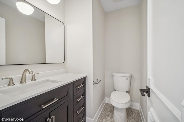 bathroom with tile patterned floors, vanity, and toilet