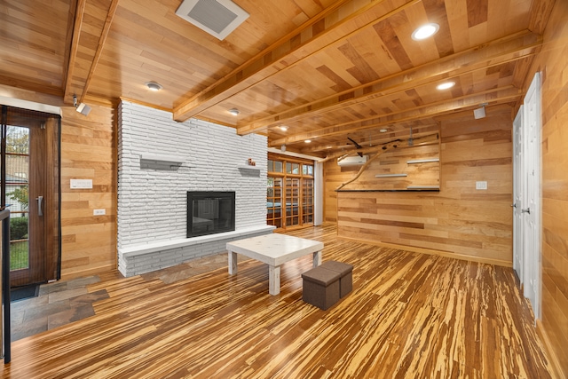 unfurnished living room with wood walls, wood-type flooring, and wood ceiling