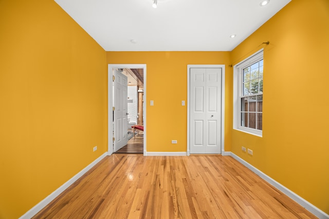 unfurnished bedroom featuring light wood-type flooring