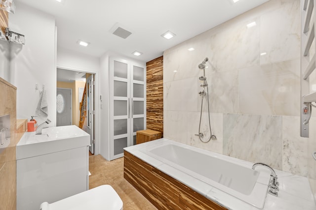 bathroom with vanity, tile walls, and shower with separate bathtub