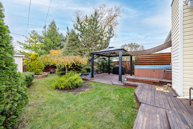 view of yard with a gazebo, a hot tub, and a deck