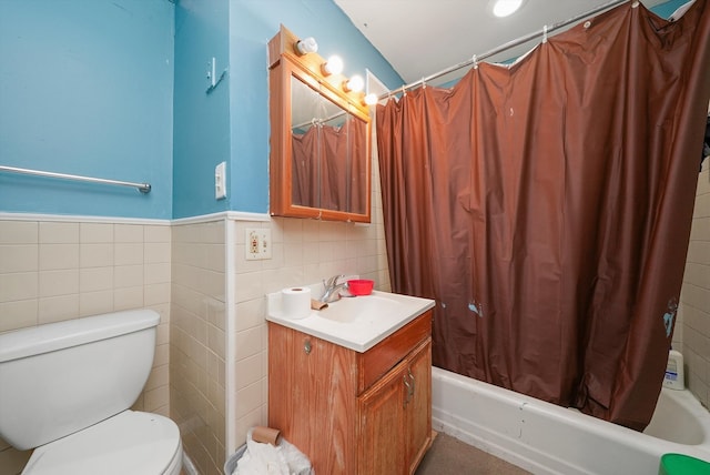 full bathroom featuring shower / tub combo with curtain, vanity, tile walls, and toilet