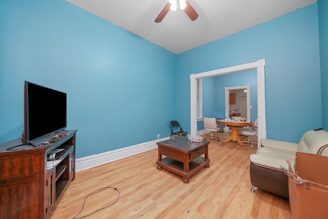 sitting room with ceiling fan and light wood-type flooring