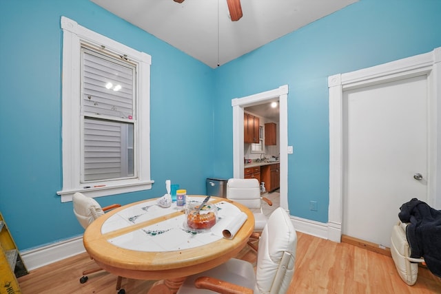 dining space with ceiling fan, sink, and light hardwood / wood-style floors