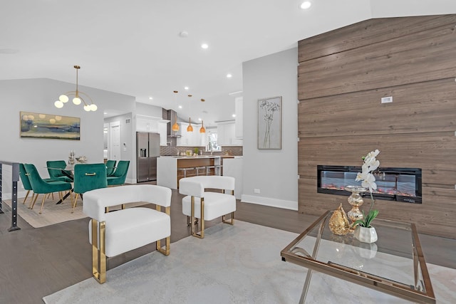 living room featuring vaulted ceiling and a fireplace