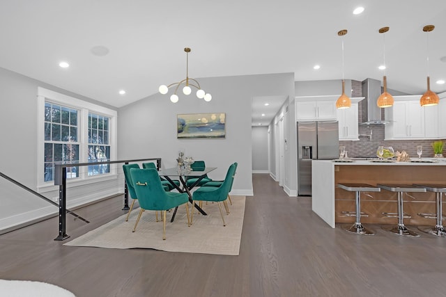 dining area featuring dark wood-type flooring and lofted ceiling