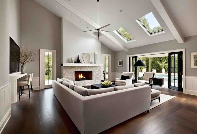 living room with a high ceiling, ceiling fan, and dark wood-type flooring