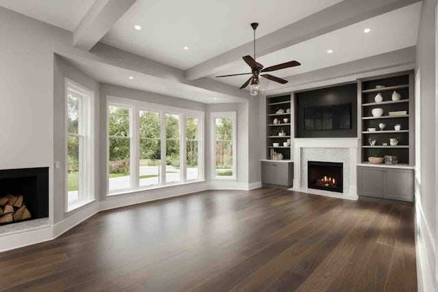 unfurnished living room with beam ceiling, built in shelves, ceiling fan, and dark wood-type flooring