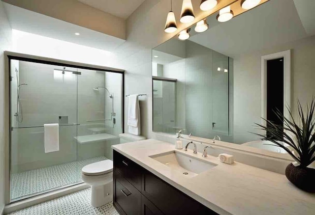 bathroom featuring vanity, a shower with shower door, and toilet