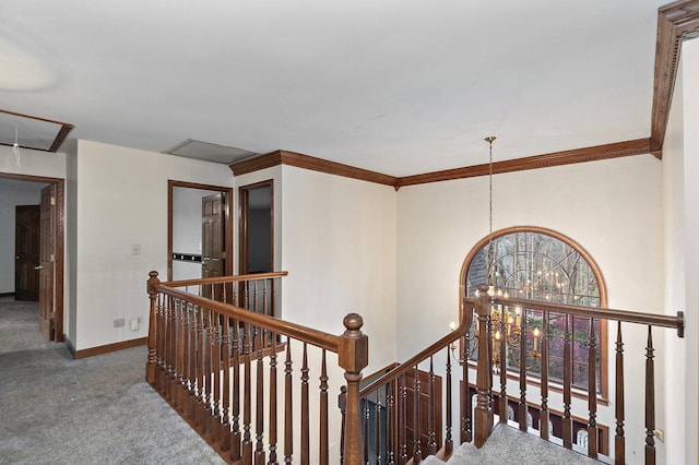 hallway with carpet flooring and a chandelier