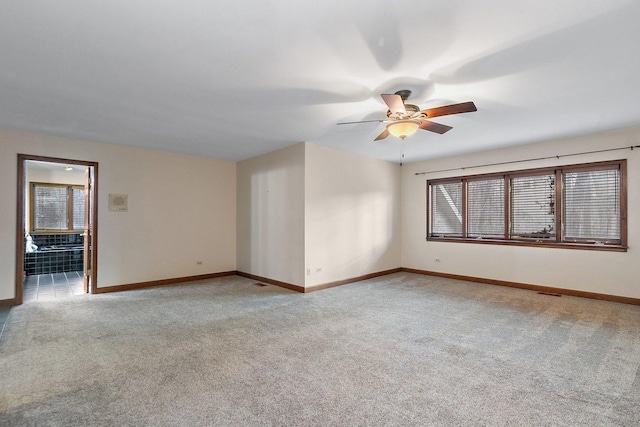 unfurnished room with ceiling fan and light colored carpet