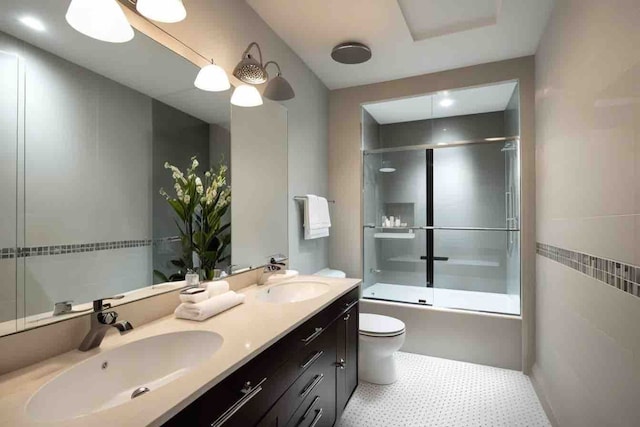 full bathroom with shower / bath combination with glass door, vanity, and toilet