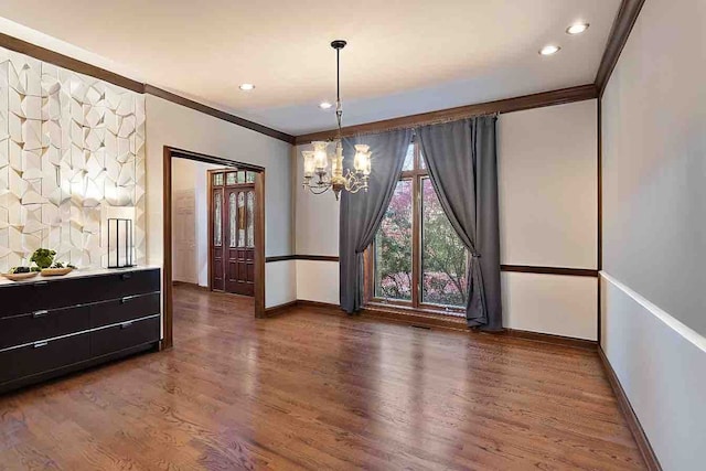 interior space with dark hardwood / wood-style floors, ornamental molding, and a chandelier