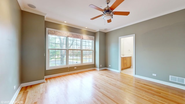 unfurnished room featuring ceiling fan, light wood-type flooring, and crown molding