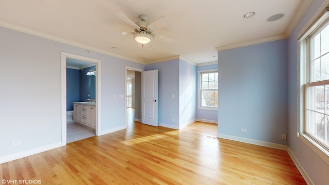 empty room featuring ceiling fan, light wood-type flooring, and ornamental molding