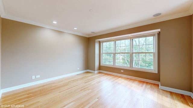 spare room featuring ornamental molding and light hardwood / wood-style flooring