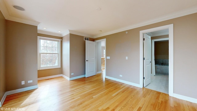 unfurnished bedroom with ensuite bathroom, light wood-type flooring, and ornamental molding