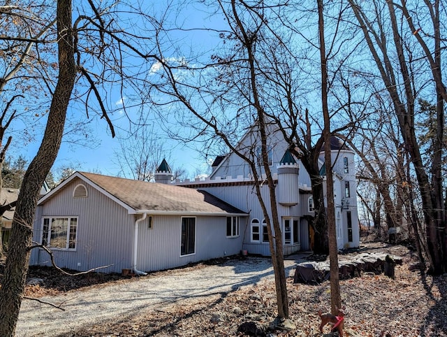 exterior space with roof with shingles