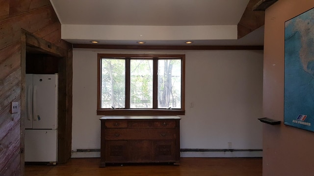 kitchen featuring baseboard heating, wood finished floors, freestanding refrigerator, and recessed lighting