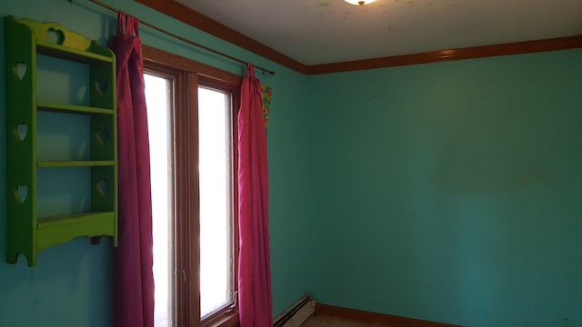 spare room with a baseboard radiator and ornamental molding