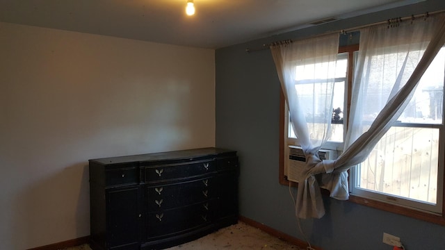 bedroom with multiple windows, visible vents, and baseboards