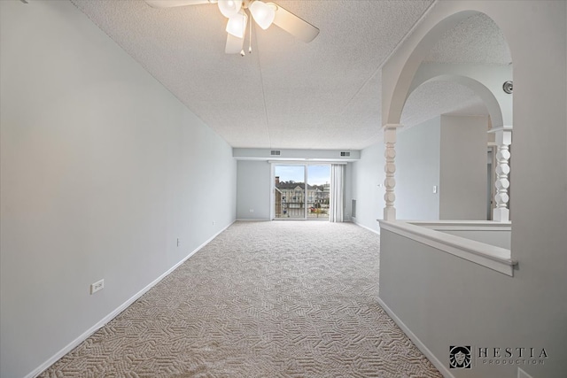 corridor featuring light colored carpet and a textured ceiling