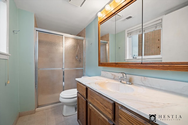 bathroom featuring tile patterned floors, a shower with door, vanity, and toilet