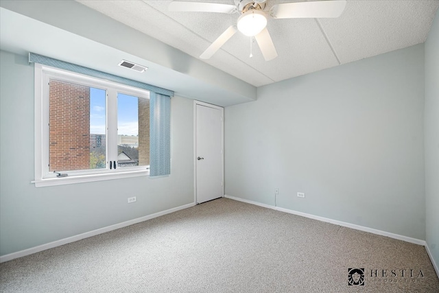 spare room featuring carpet flooring and ceiling fan