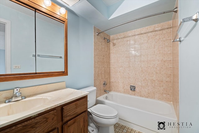 full bathroom with tile patterned floors, vanity, toilet, and tiled shower / bath combo