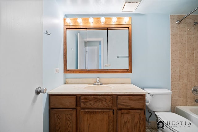 full bathroom with vanity, toilet, and tiled shower / bath