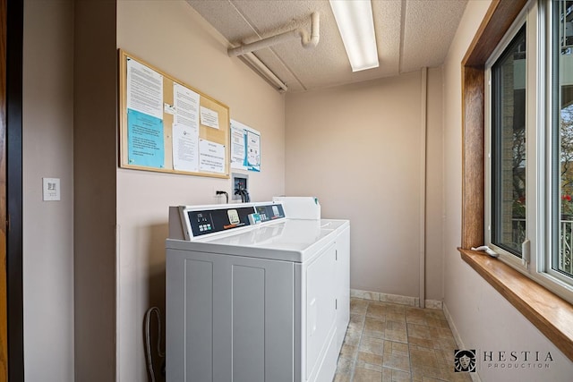 laundry area featuring independent washer and dryer and a textured ceiling