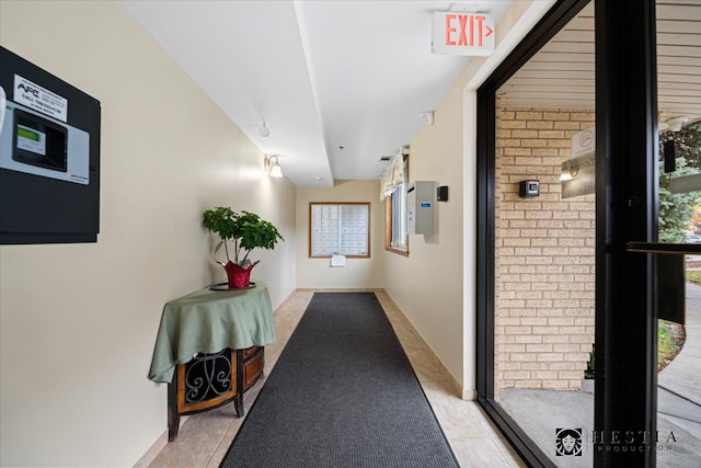 hall featuring light tile patterned floors