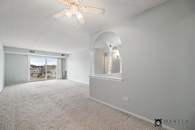 carpeted empty room with a textured ceiling and ceiling fan