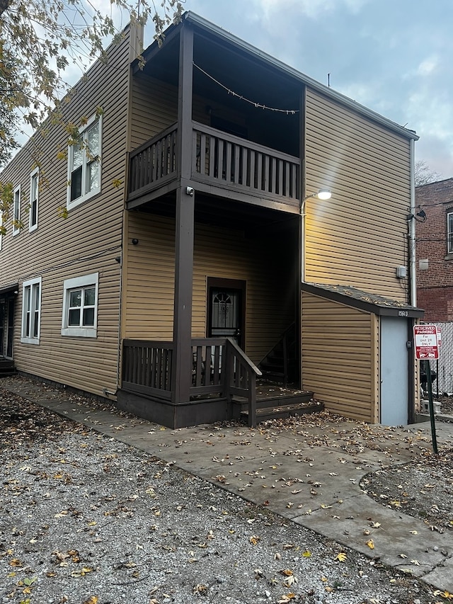 back of property featuring a balcony