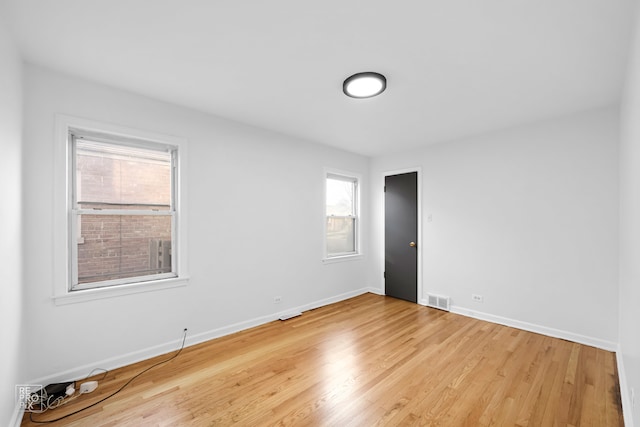 empty room with light hardwood / wood-style floors