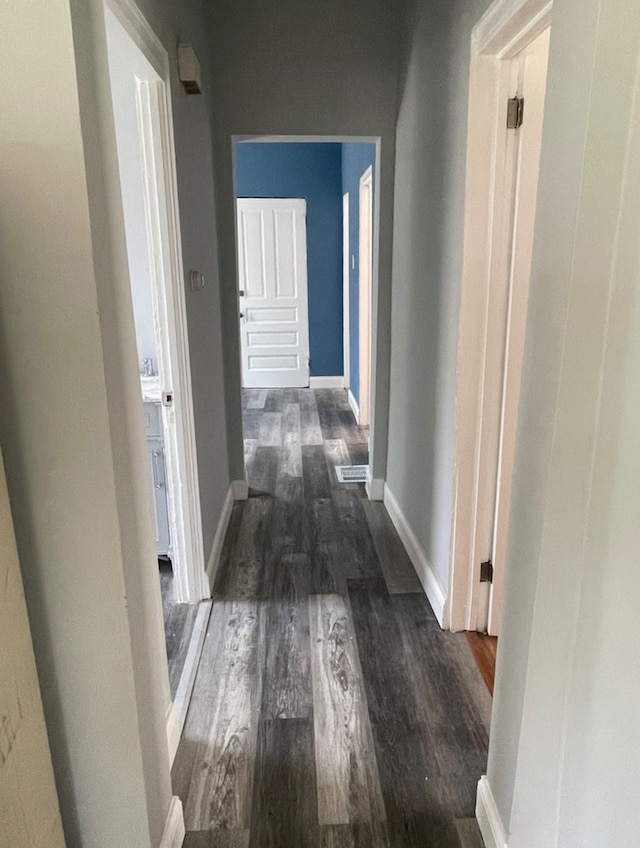 corridor featuring dark wood-type flooring