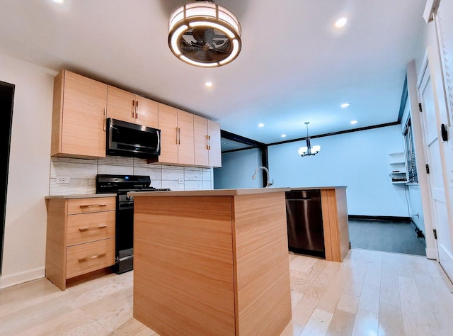 kitchen featuring a center island, dishwasher, black range oven, hanging light fixtures, and light brown cabinetry