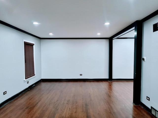 unfurnished room featuring dark hardwood / wood-style floors and ornamental molding