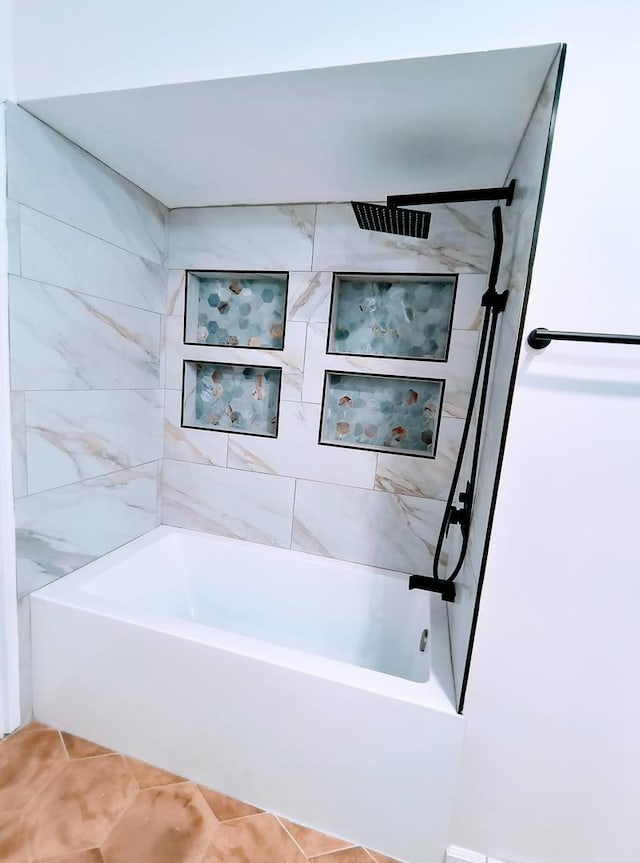 bathroom with tile patterned flooring and tiled shower / bath